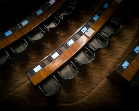 low light photography of armchairs in front of desk