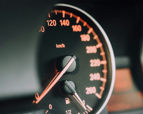 closeup photo of black analog speedometer