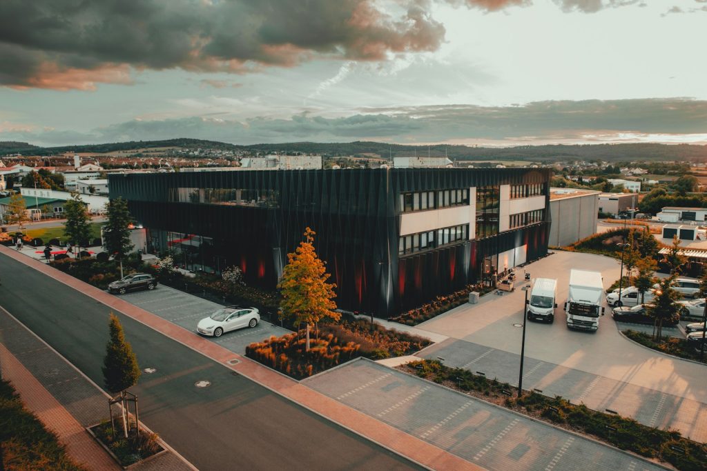 cars parked on parking lot near building during daytime