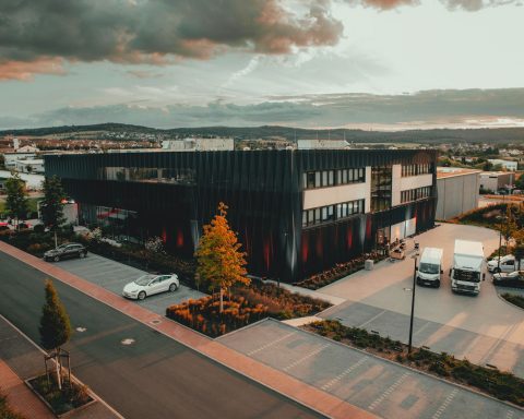 cars parked on parking lot near building during daytime