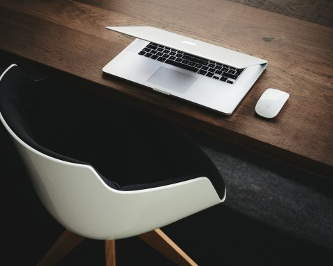 Apple MacBook beside computer mouse on table