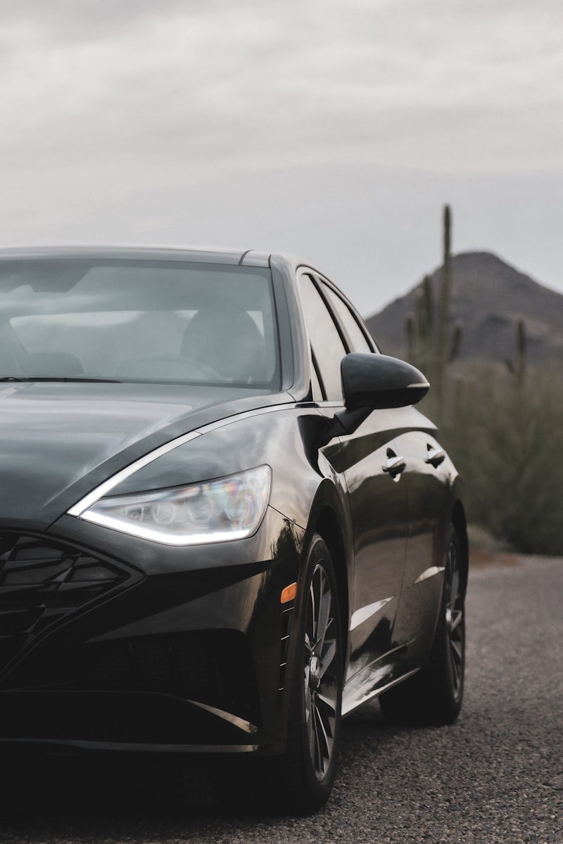 black sedan parking near road