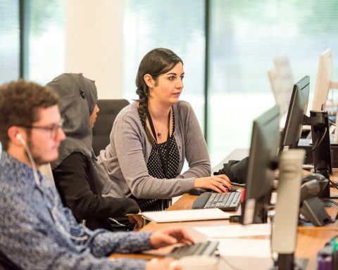 unknown persons using computer indoors