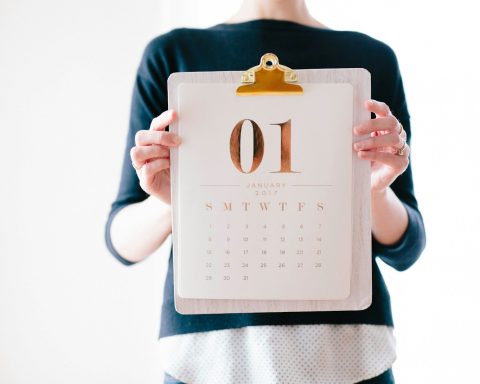 person holding calendar at January