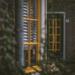 a green door with a yellow window frame