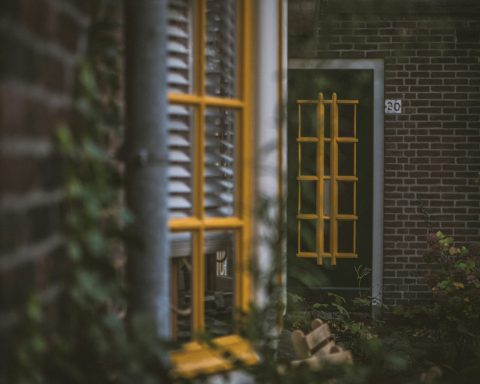 a green door with a yellow window frame