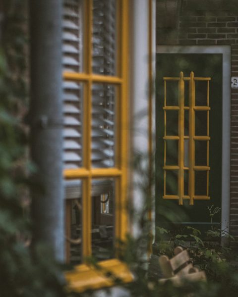 a green door with a yellow window frame