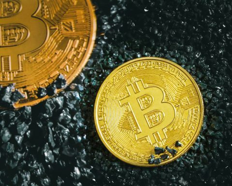 a bitcoin sitting next to a bitcoin on the ground