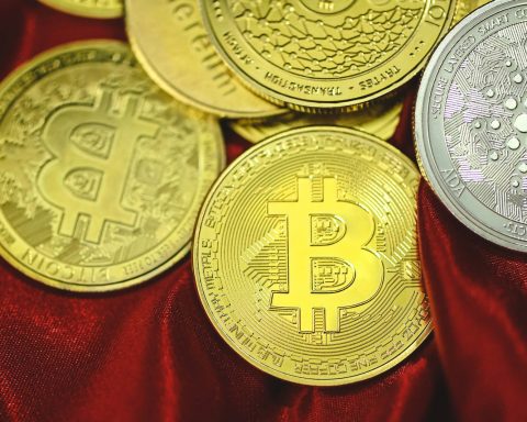 a pile of bitcoins sitting on top of a red cloth