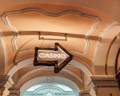 a casino sign hanging from the ceiling of a building