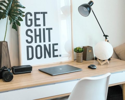 brown and white wooden desk with chair and laptop