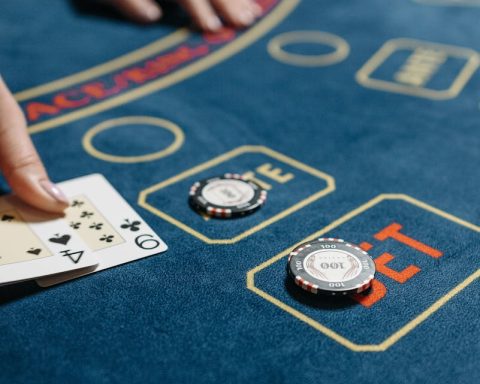 High-stakes card game on a casino table featuring poker chips and a dealt hand.