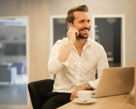 man using smartphone on chair