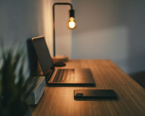 black laptop computer on brown wooden table