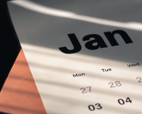 a calendar sitting on top of a wooden table