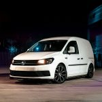 a white van parked in a parking lot at night