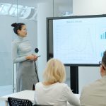 Woman presenting a graph to an audience