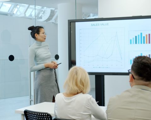 Woman presenting a graph to an audience