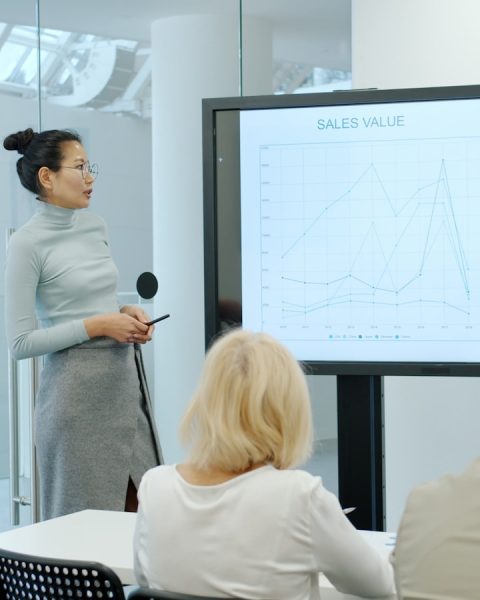 Woman presenting a graph to an audience