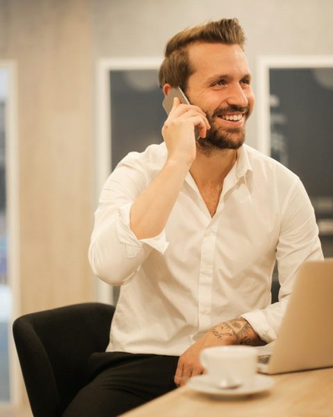 man using smartphone on chair