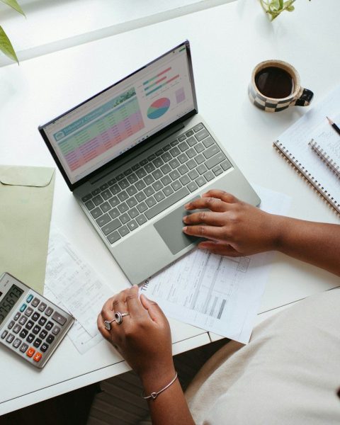 a person sitting at a table with a laptop